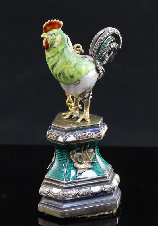 An Austro-Hungarian style baroque pearl, rose diamond and emerald set model of a cockerel, now on silver and enamel stand,